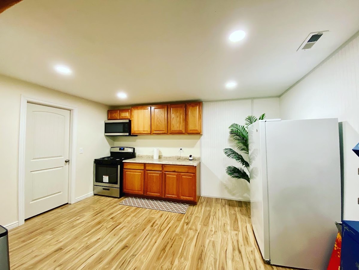 Renovated basement kitchenette with recessed lighting