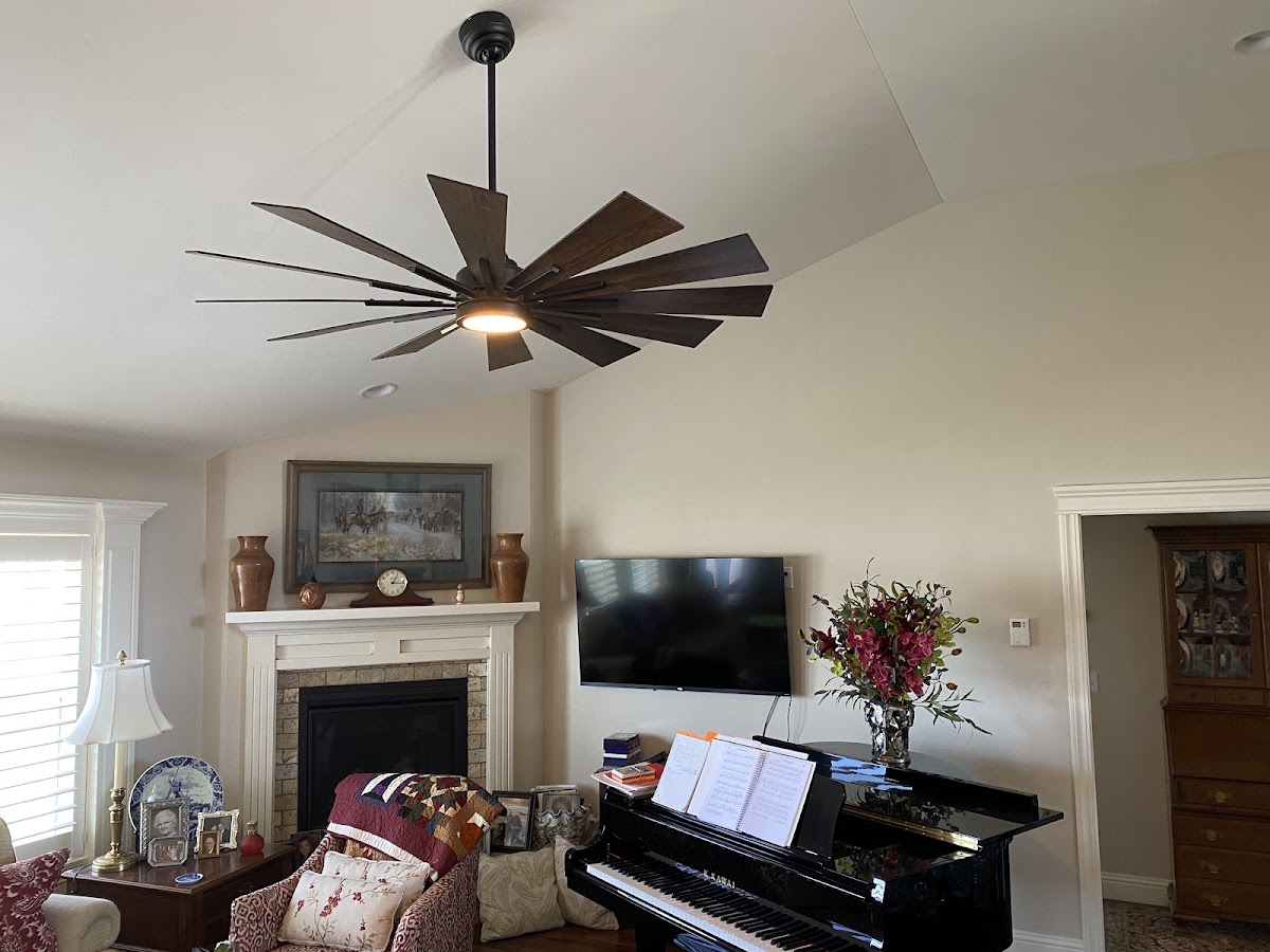 Large windmill style ceiling fan installed in a living room